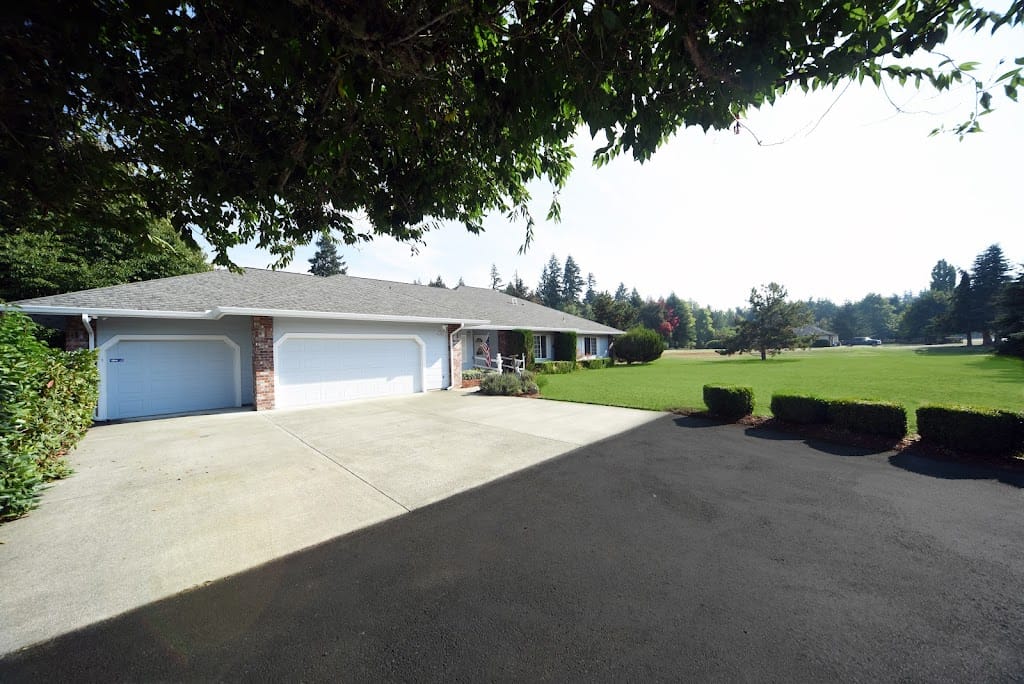 Exterior view of Canterwood Estates with a lawn and driveway
