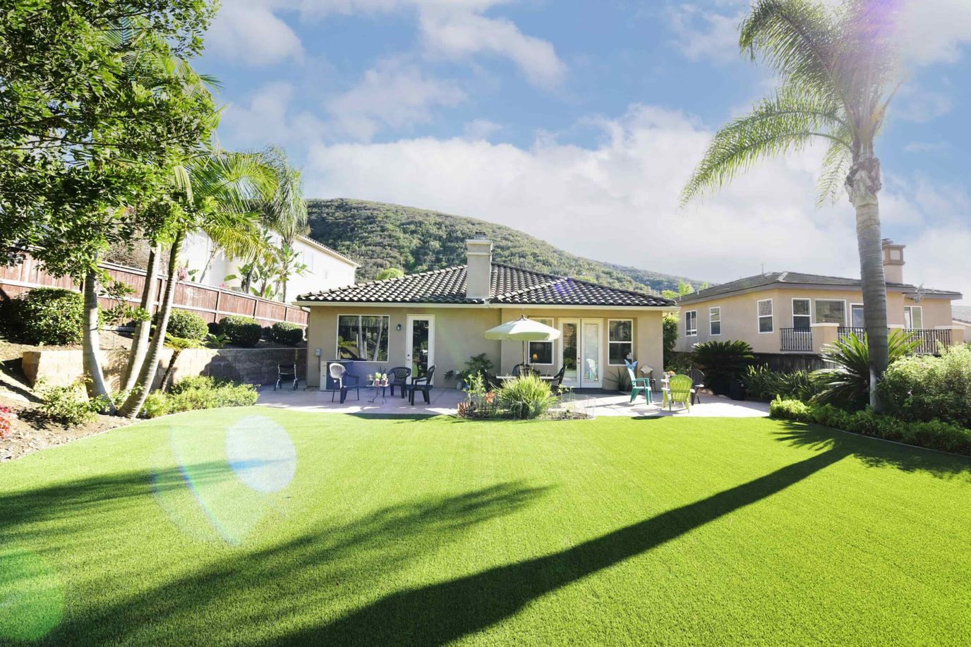 Exterior view of a facility surrounded by green lawn and palm trees