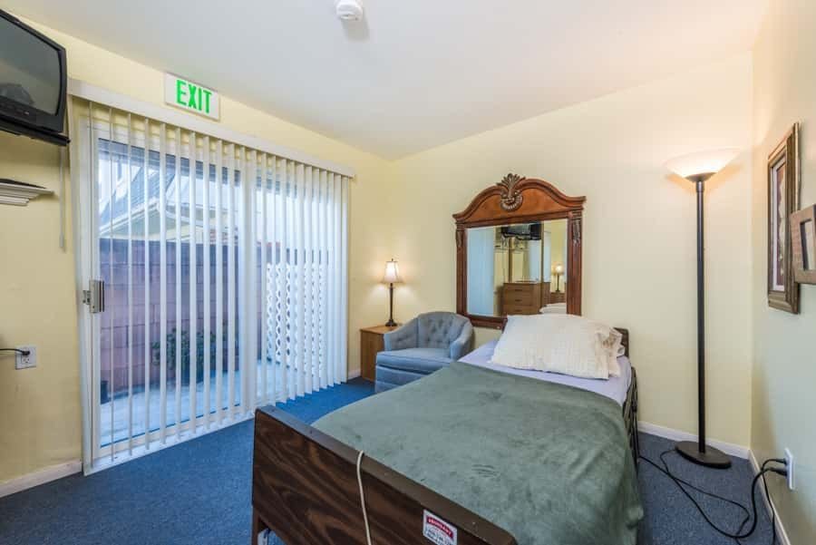 Cozy private resident room with a bed and seating area