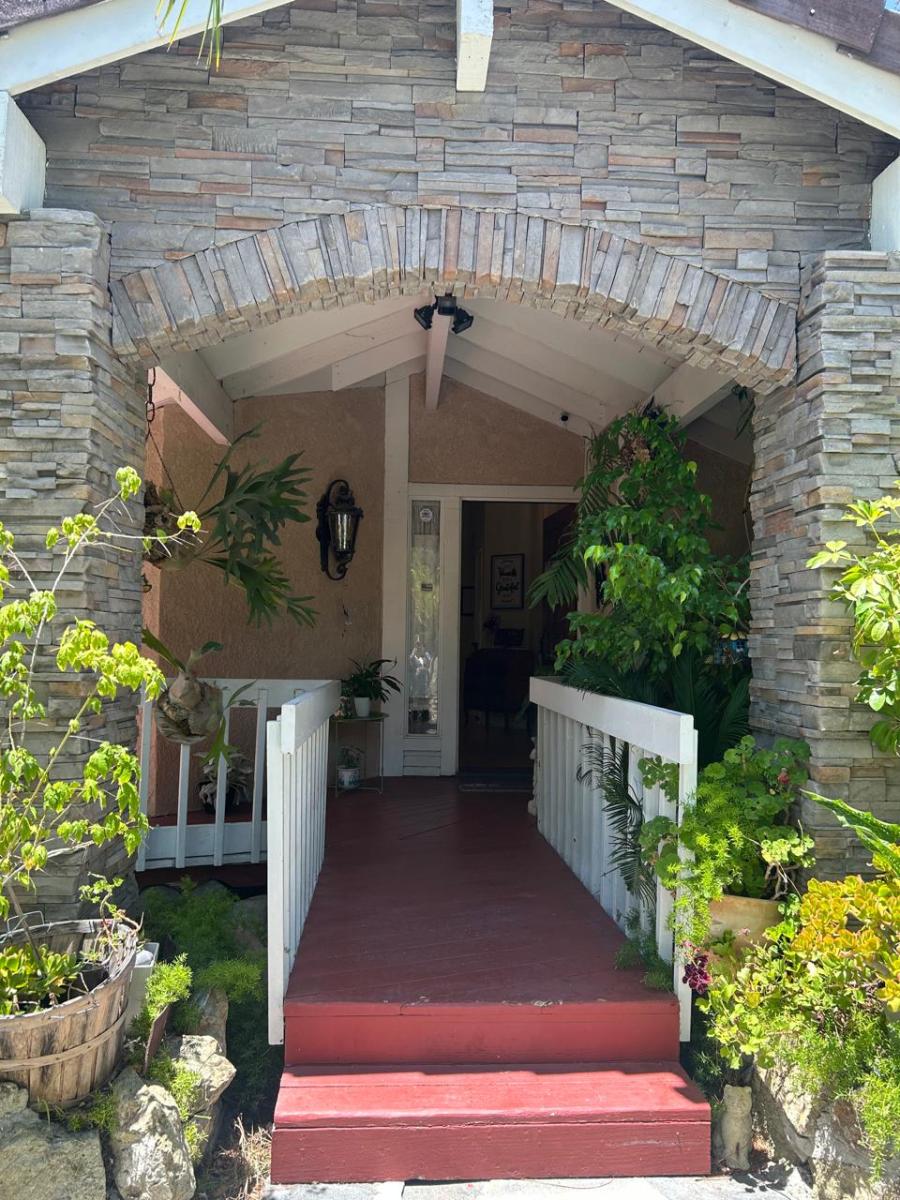 Entrance of a residential facility surrounded by greenery