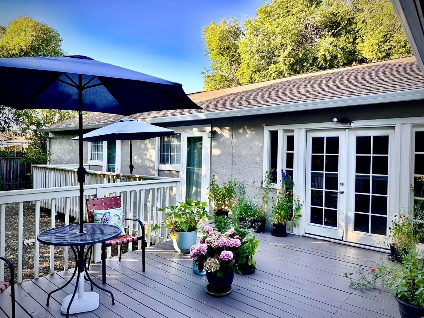 Outdoor patio with flowers and seating area