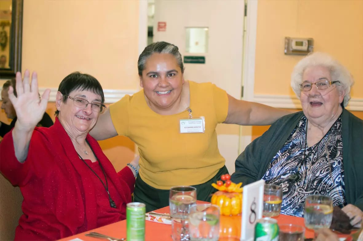 Residents and staff enjoying a meal together