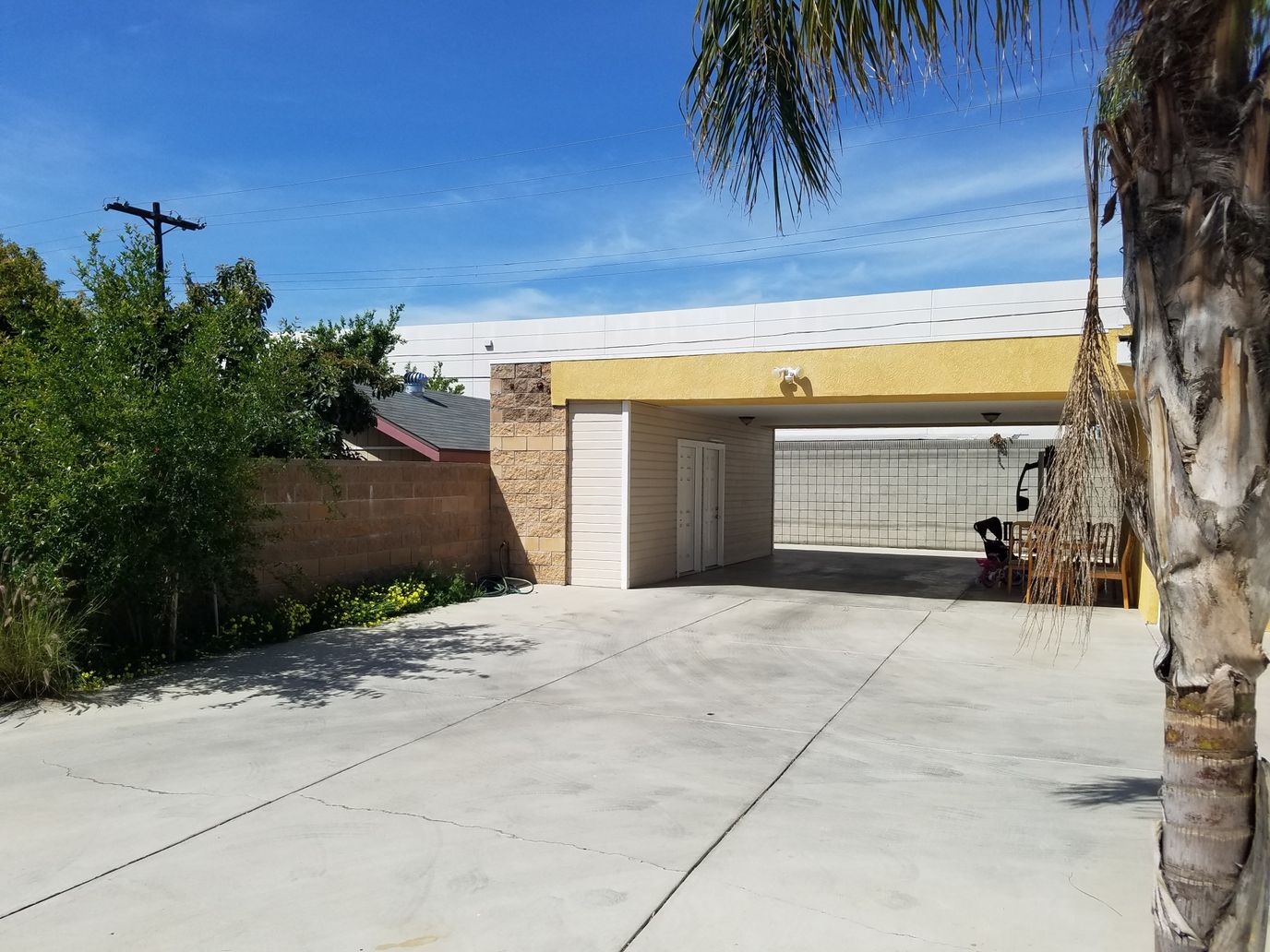 Covered parking area with palm trees