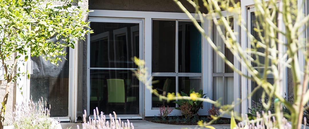 Entrance to an assisted living facility with outdoor plants