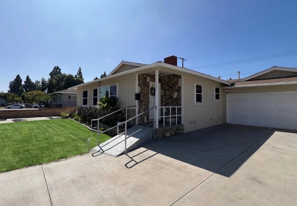 Exterior view of a senior living facility with garden