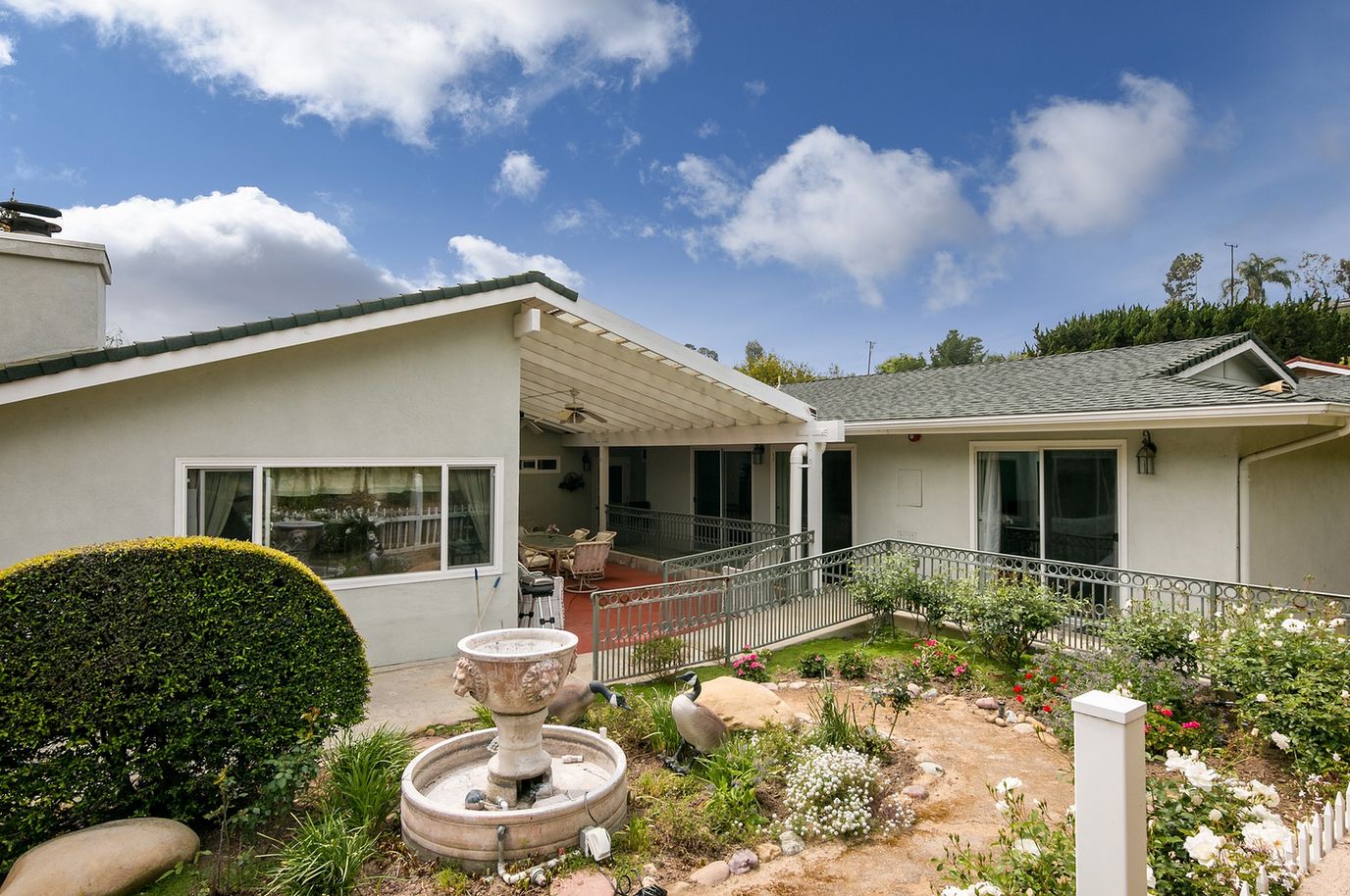 Exterior view of the facility with garden and fountain