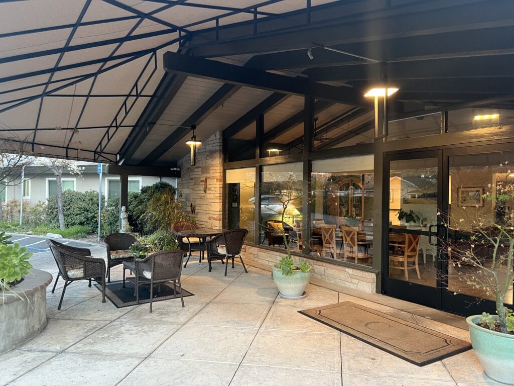 Covered outdoor seating area near the facility entrance