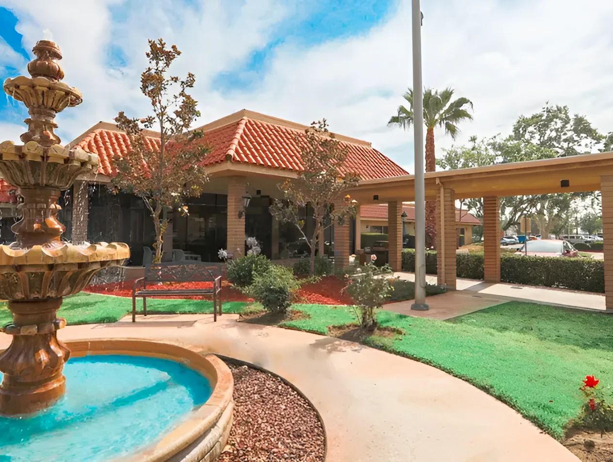 Exterior view of the facility with fountain and landscaping