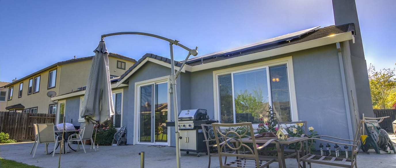 Exterior view of a residential building with patio furniture
