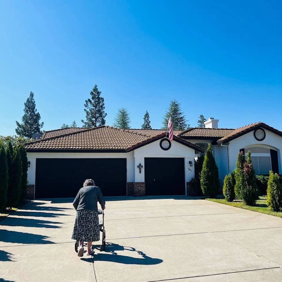 A woman with a walker in front of a residential building