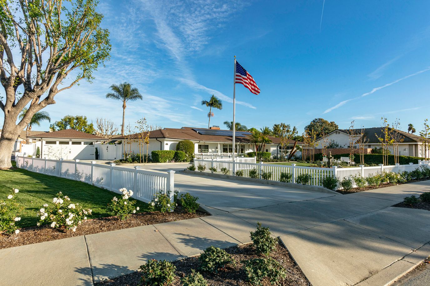 Exterior view of an assisted living facility with American flag