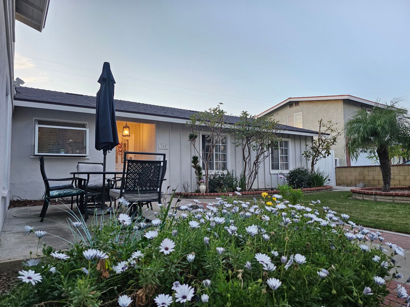 Exterior view of a facility with flowers and outdoor seating
