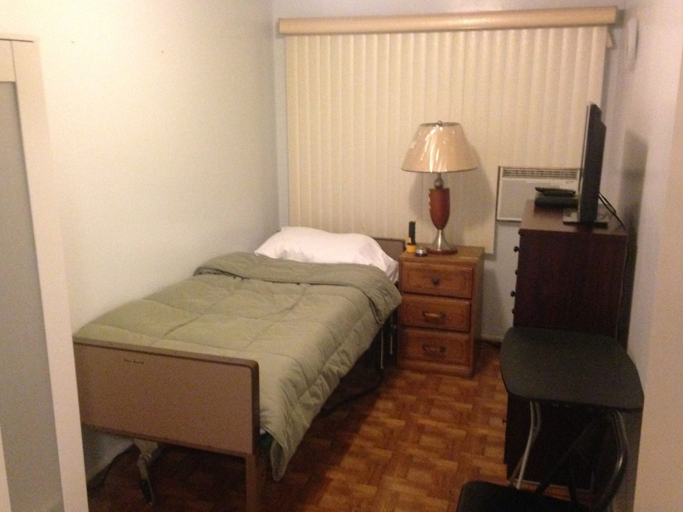 Private resident room with bed and nightstand