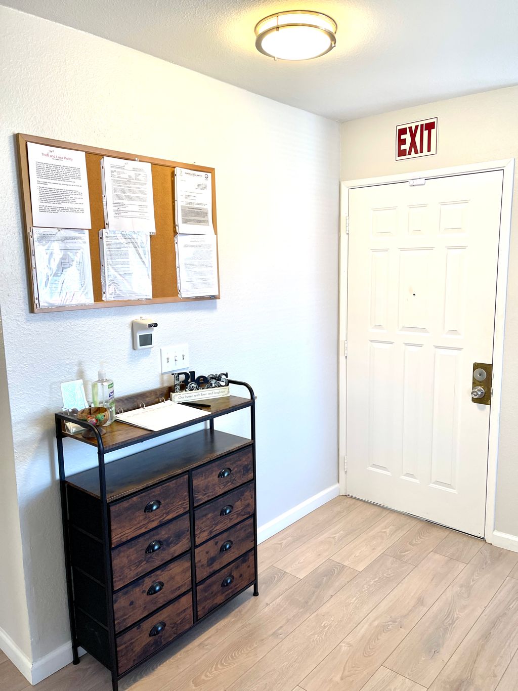 Interior hallway with bulletin board and exit sign