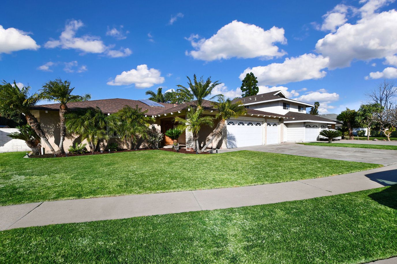 Exterior view of Living the Dream Care Home with landscaped lawn