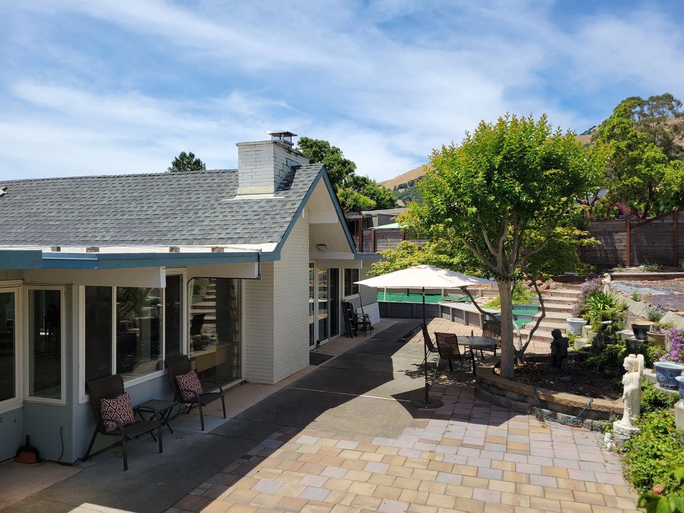 Exterior view of a senior living facility with outdoor seating