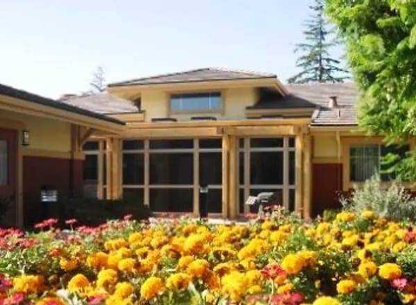Exterior view of a senior living facility with colorful flowers