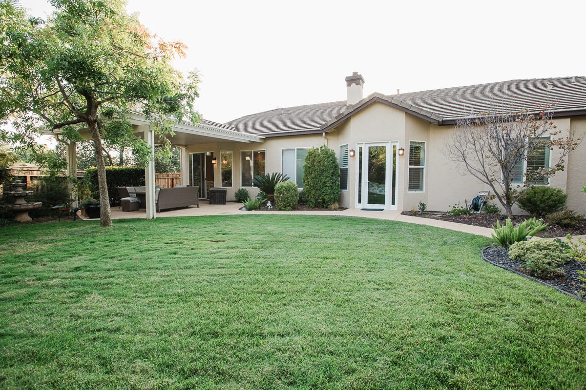 Well-maintained outdoor space with grass and seating area