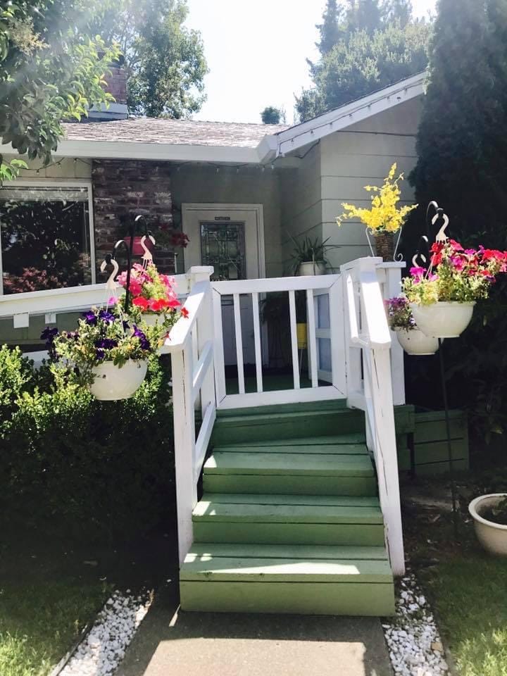 Entrance with colorful flowers and green stairs