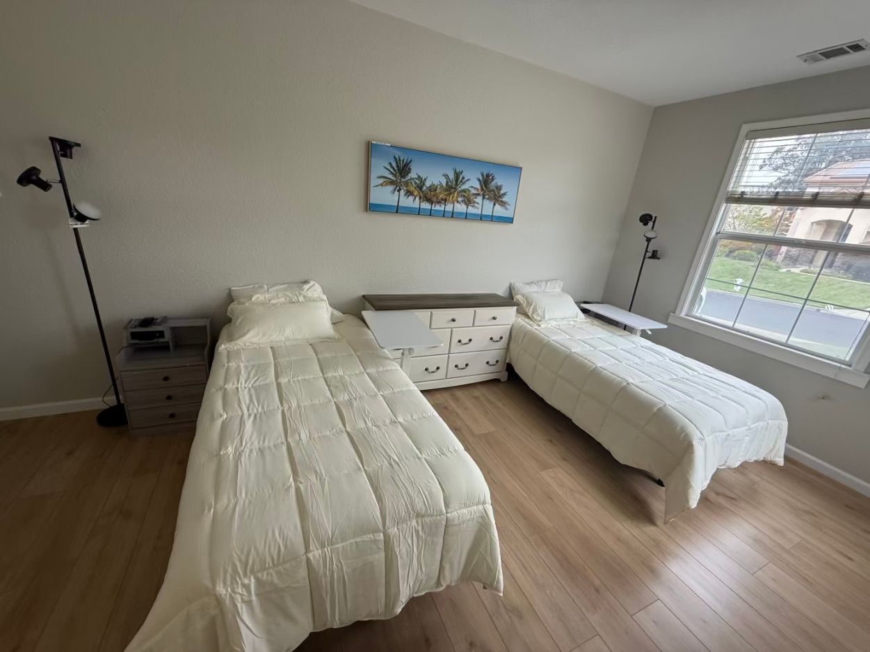 Spacious resident room with two beds and natural light