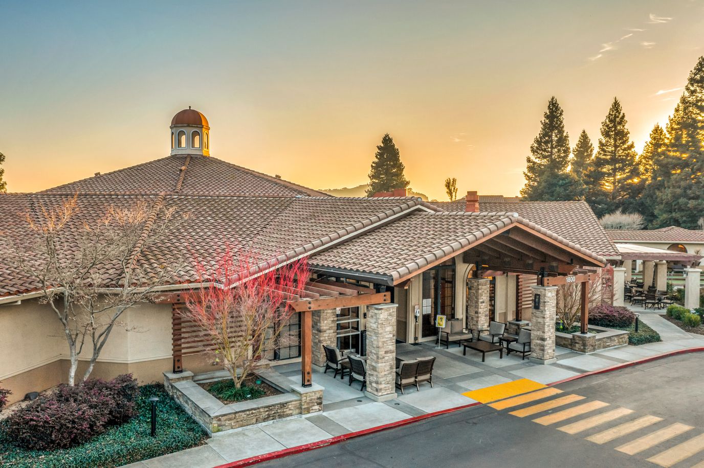 Exterior view of a senior living facility at sunset