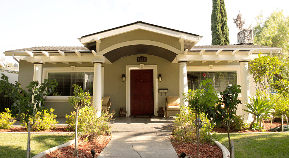 Front view of a senior living facility with garden