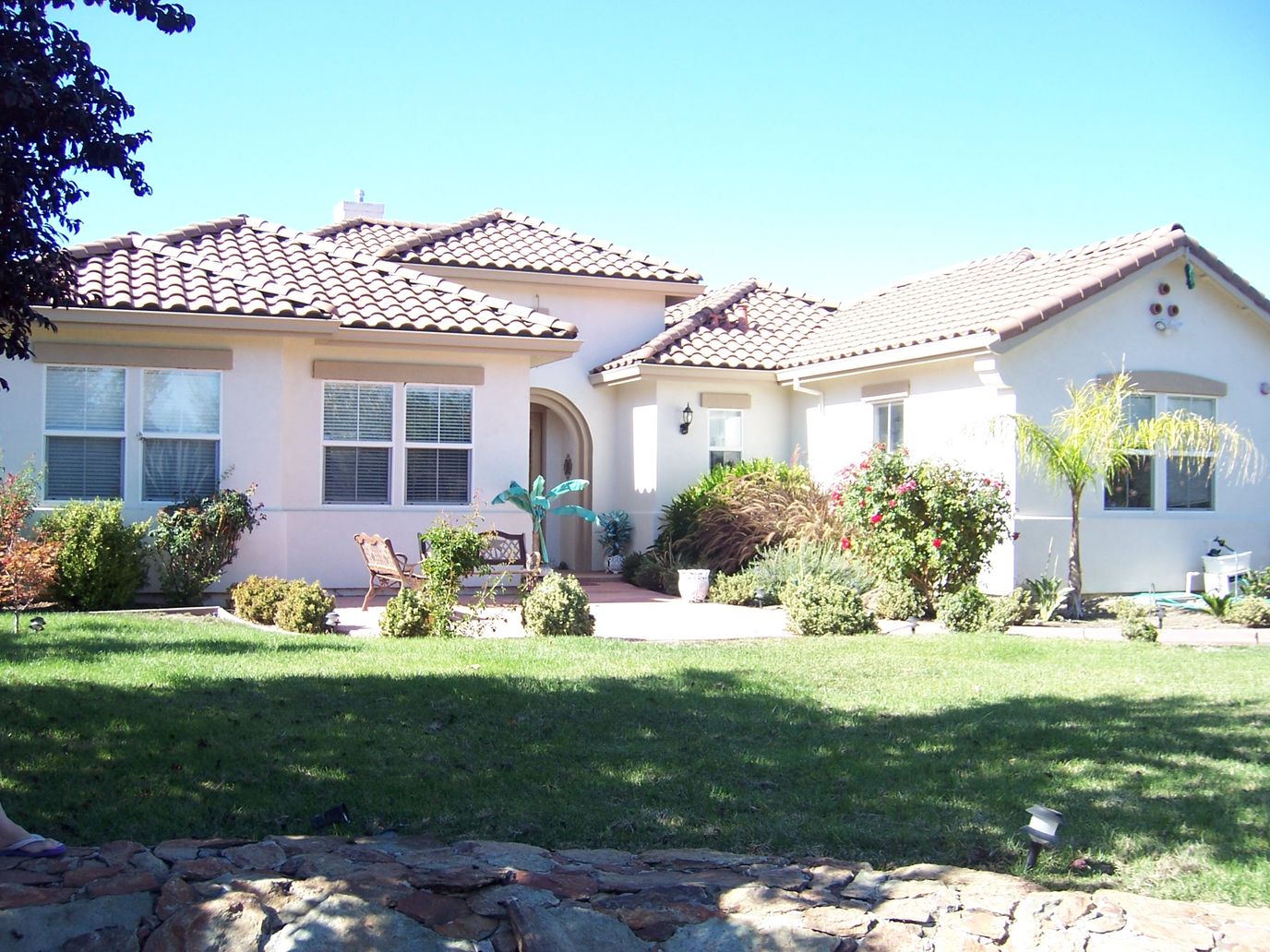 Exterior view of a senior living facility with gardens