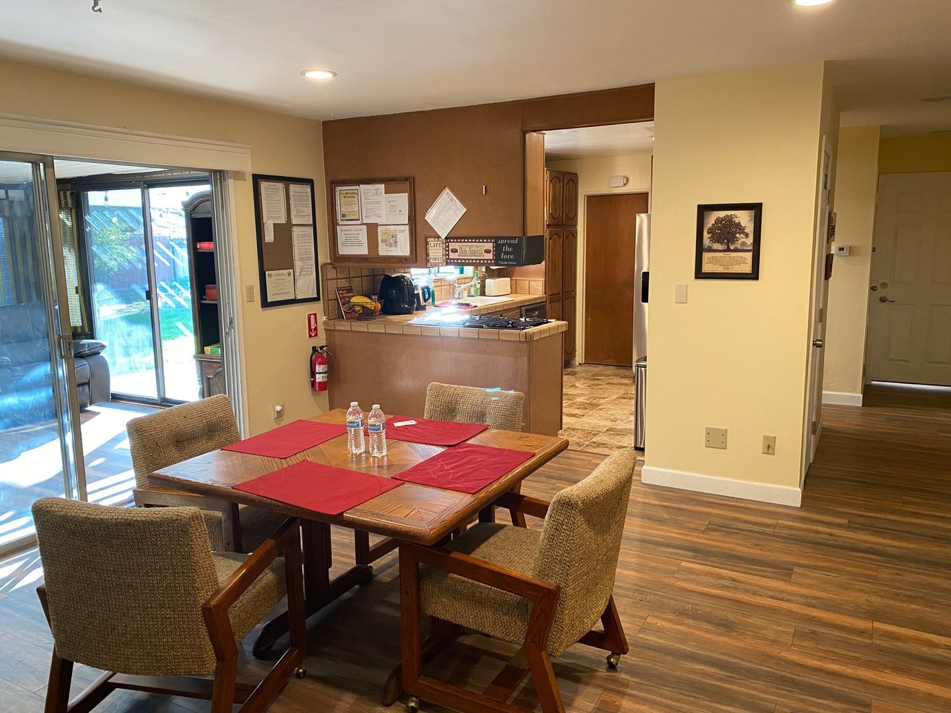 Common area with a dining table and kitchen view