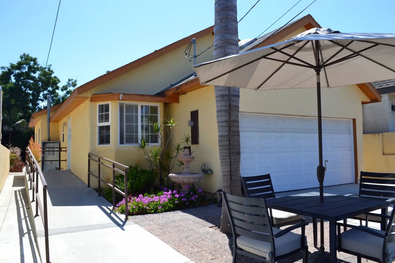 Exterior view of a senior living facility with outdoor seating