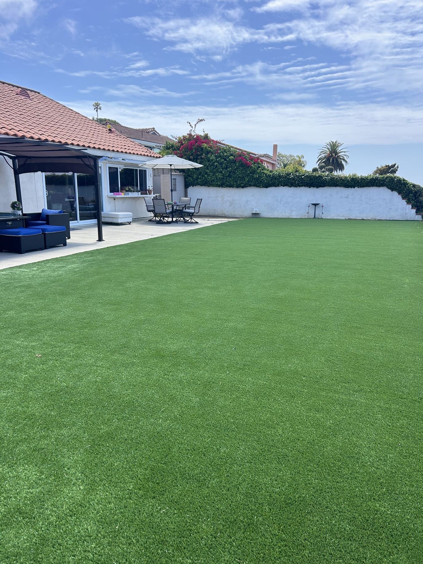 Well-maintained outdoor space with artificial grass and seating
