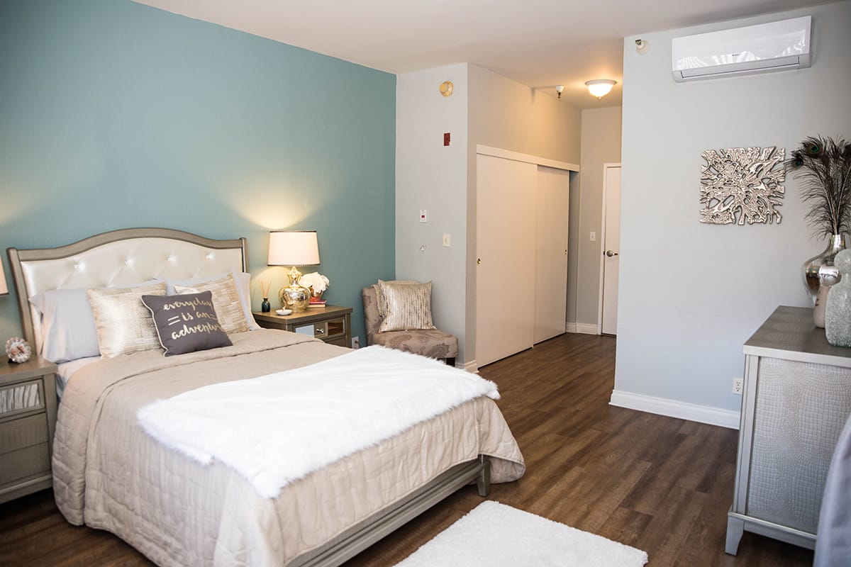 Cozy interior of a resident room with a bed and decor