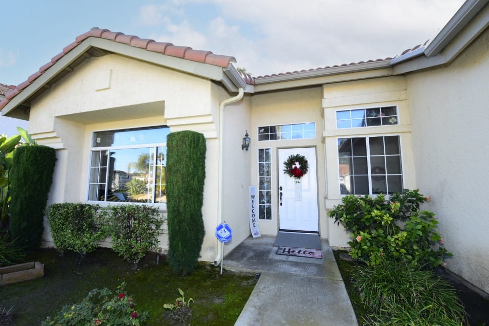 Exterior view of a senior care facility with welcome wreath