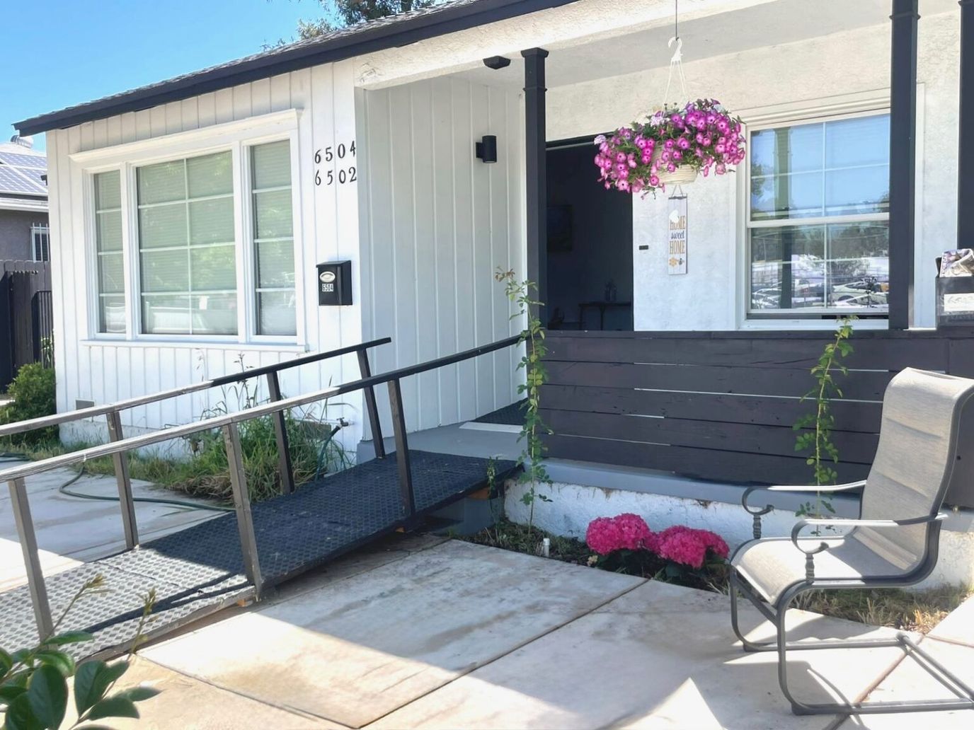 Facade of a senior care facility with flowers and seating