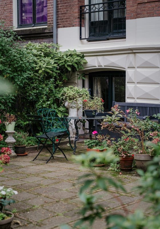 Outdoor patio with greenery and seating area