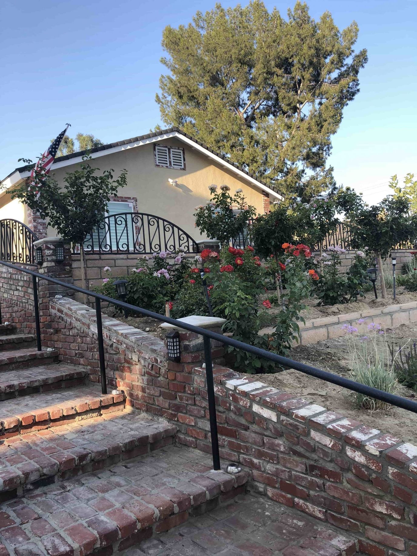 Outdoor view of a garden area with flowers and stairs