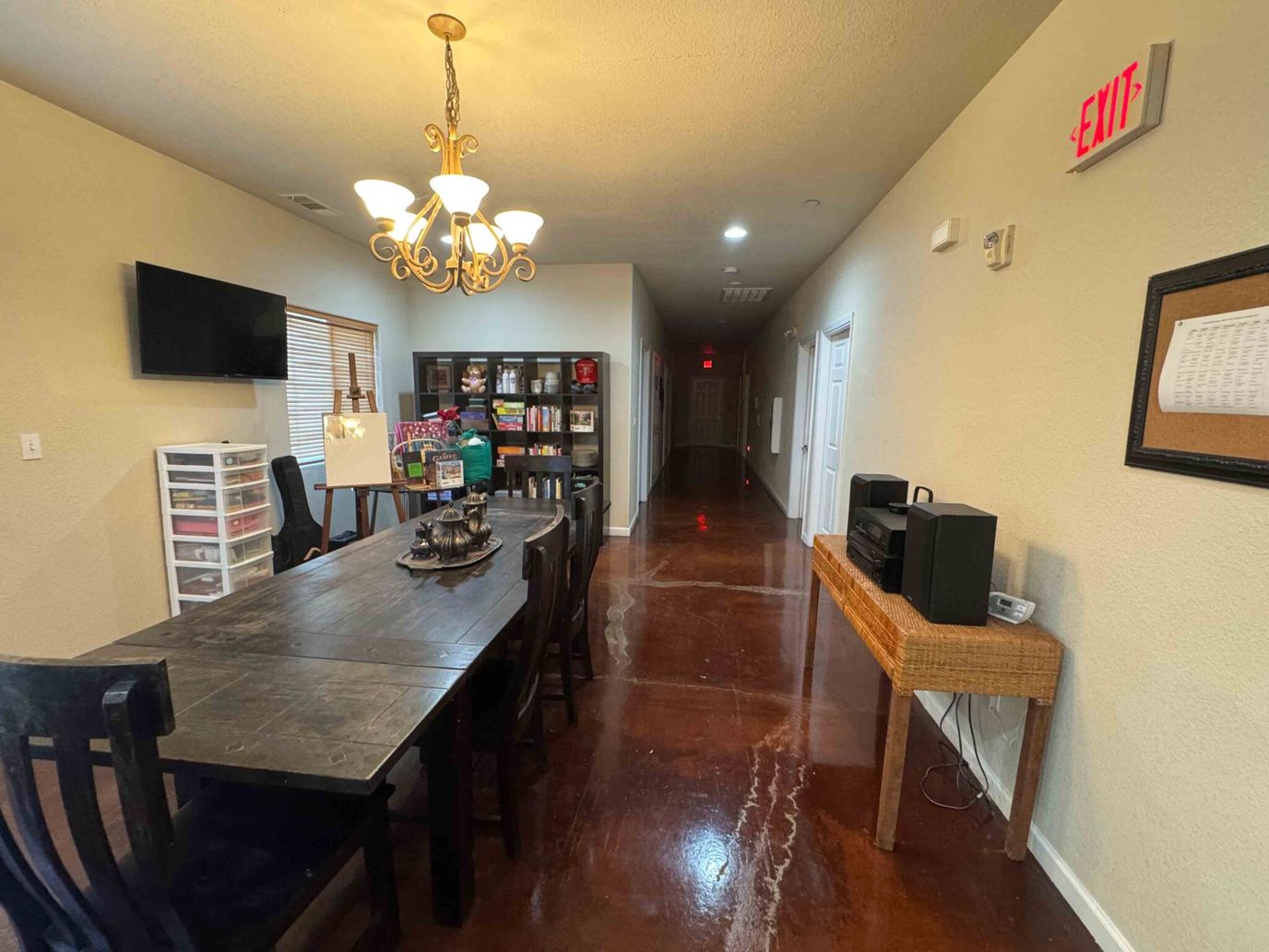 Brightly lit common area with a dining table