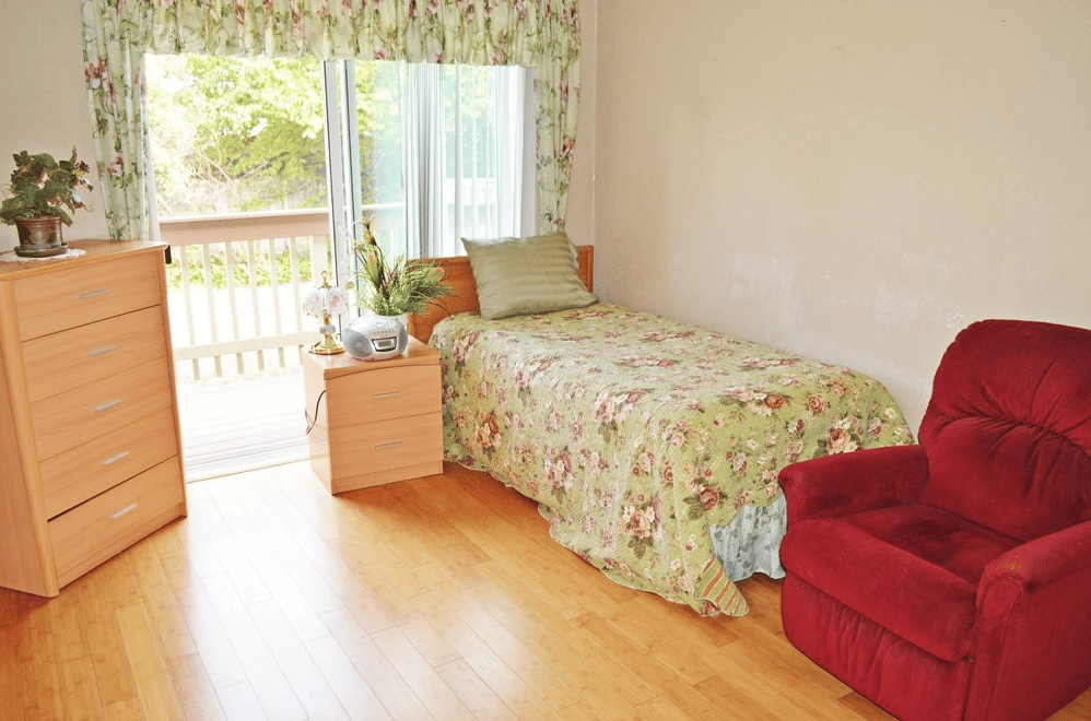 Cozy resident room with a bed and seating area