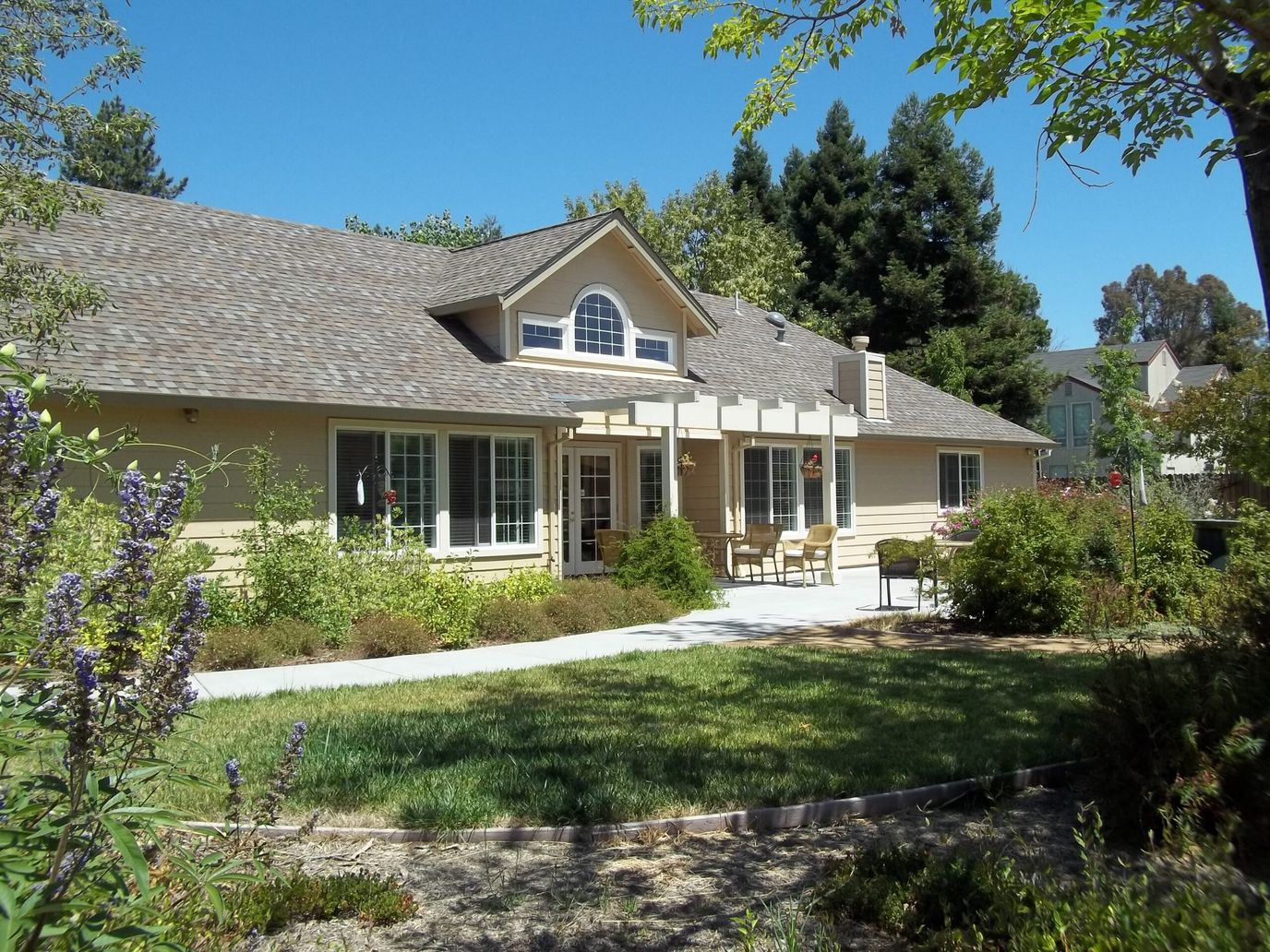 Exterior view of a senior living home with garden
