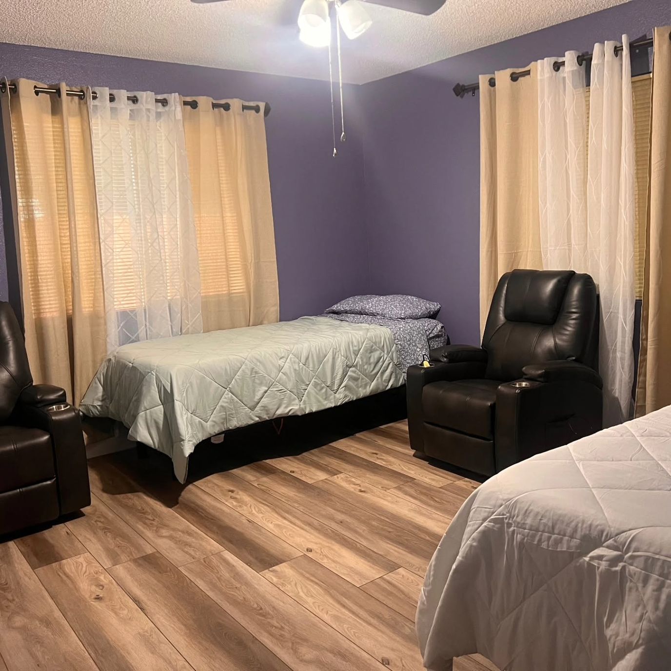 Private resident room with two beds and seating