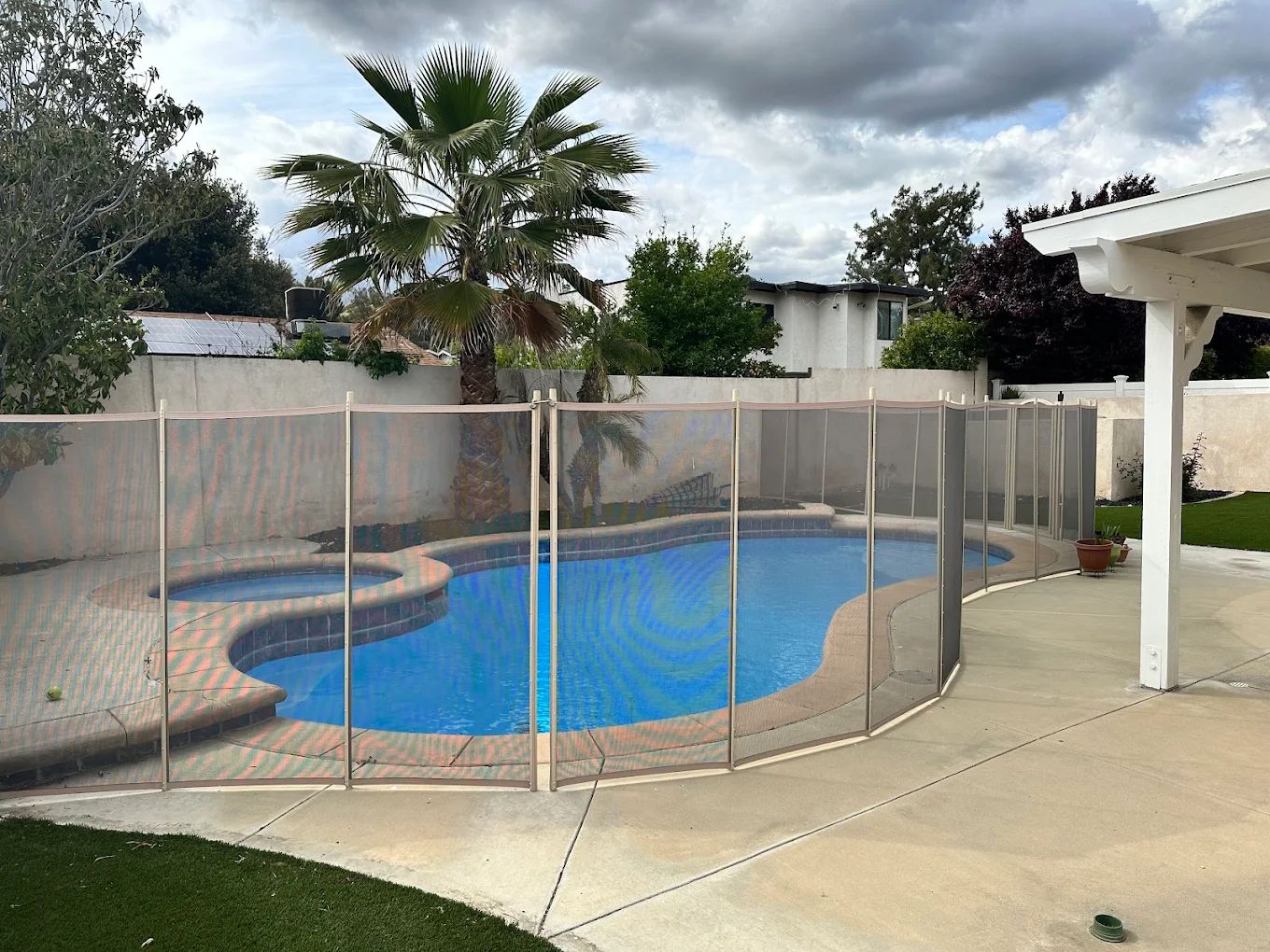 Outdoor pool area with a safety fence