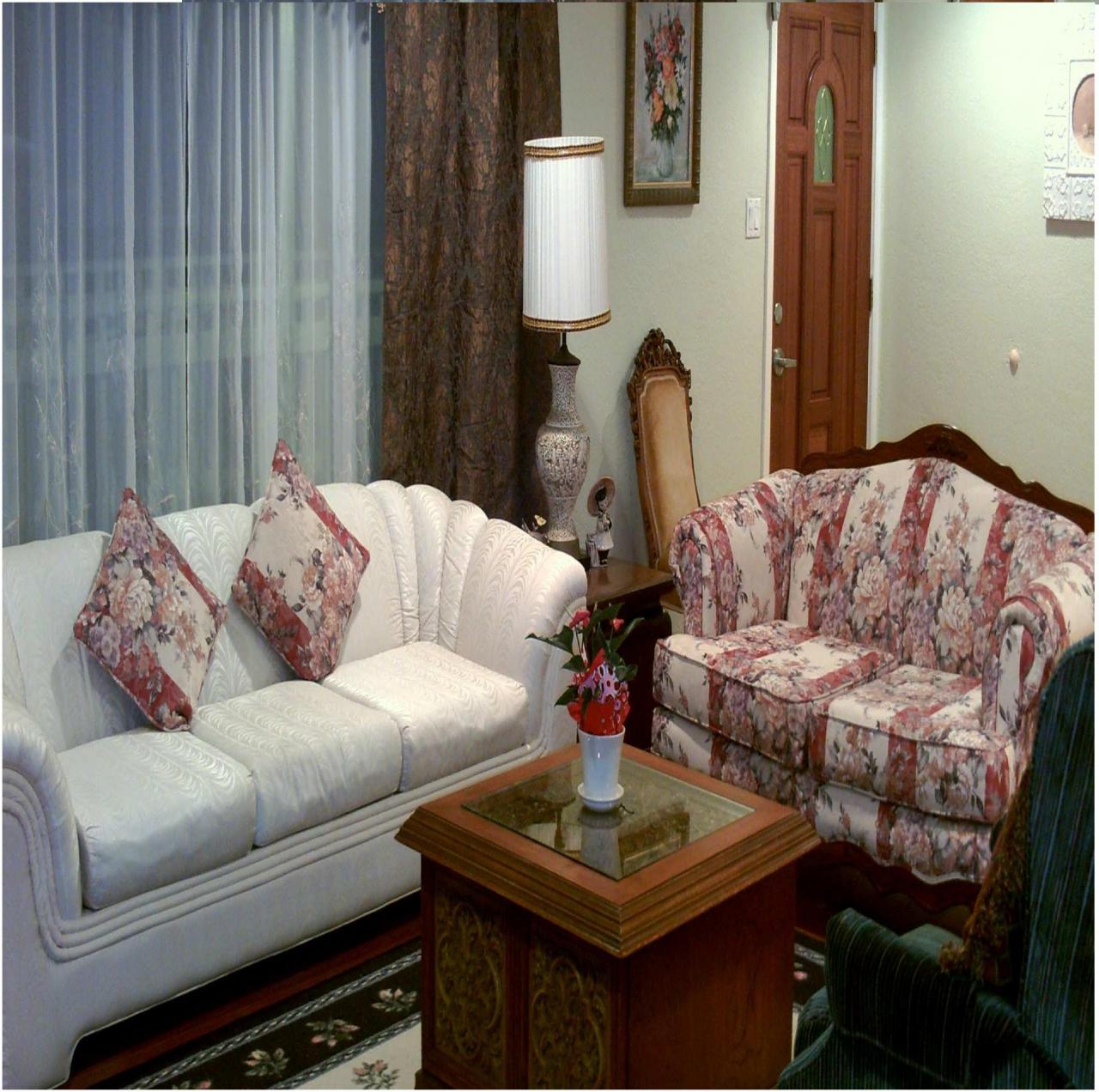 Cozy common area with floral sofas and a coffee table