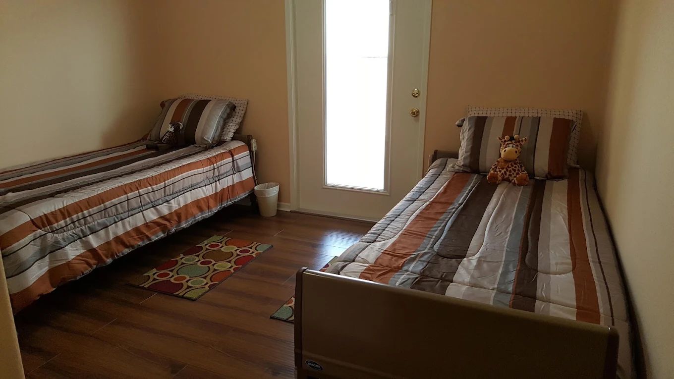 Private room with two beds and a door to outside