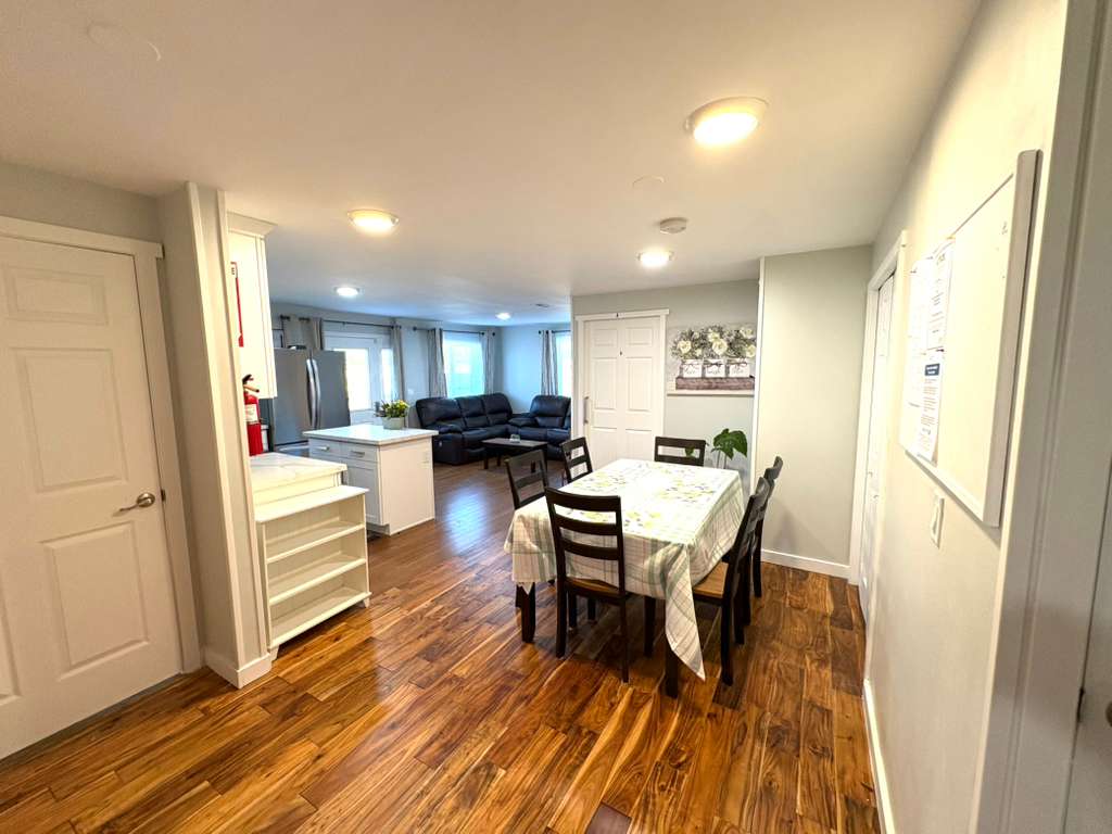 Bright common area with dining table and seating