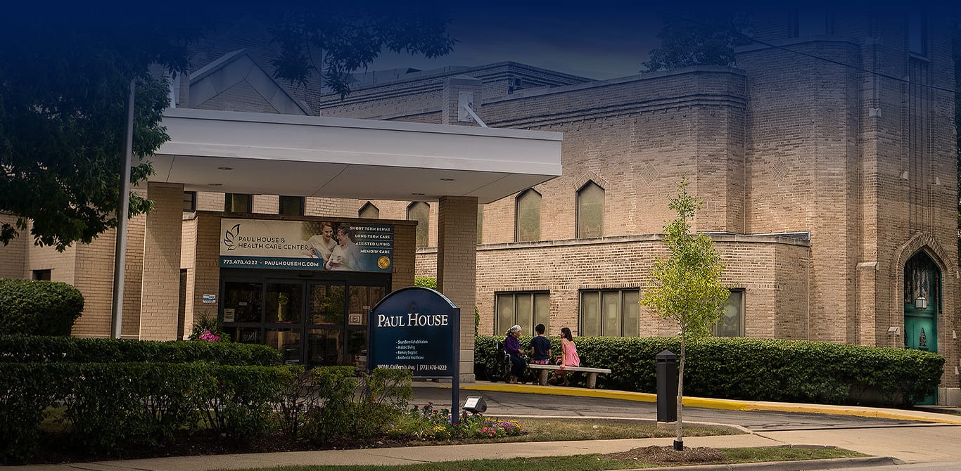 Residents socializing outside the Paul House entrance