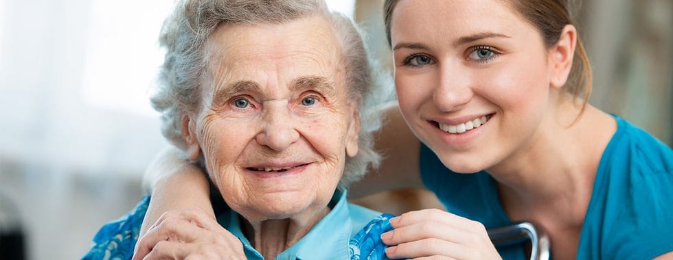 Smiling elderly woman with caregiver