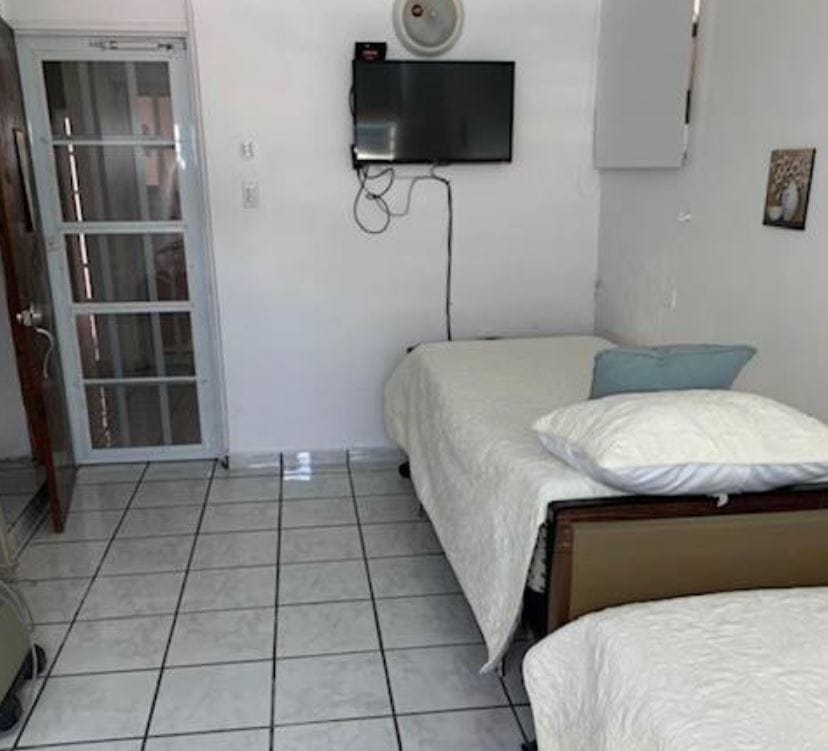 Interior view of a resident's room with two beds