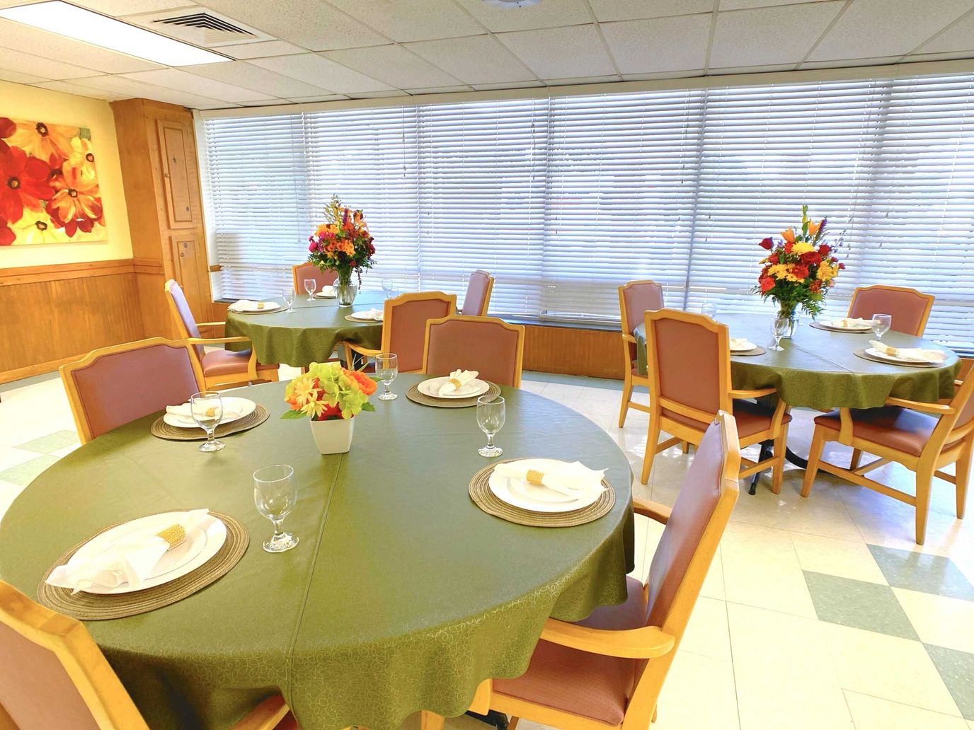 Dining room setup with flower arrangements and table settings