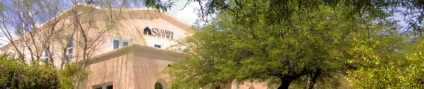 Exterior view of Saint Luke's Home with trees