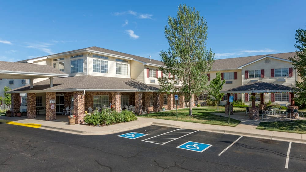 Exterior view of Crossroads Care Center with outdoor seating