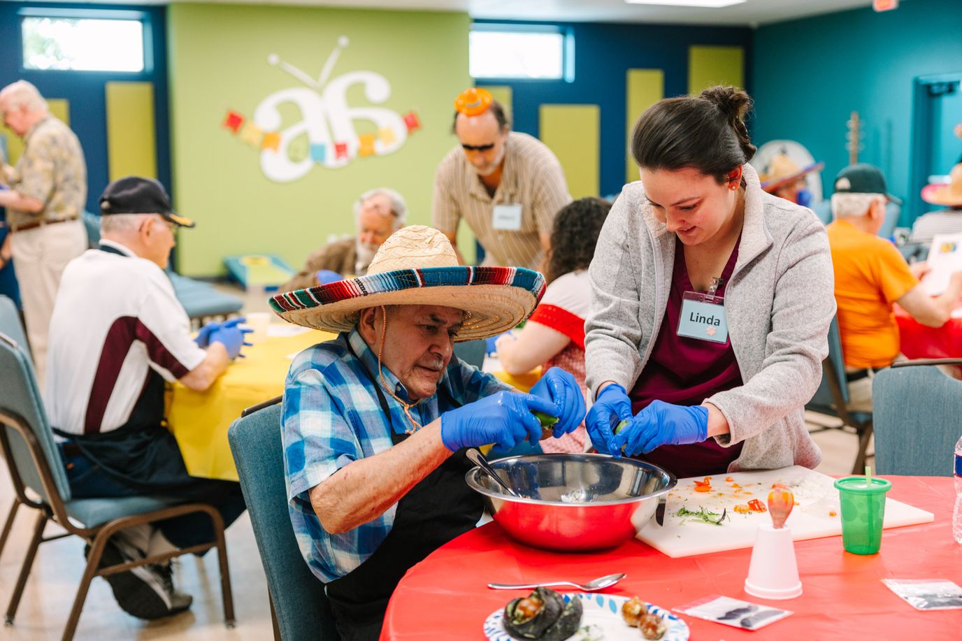 Residents participating in an activity with staff assistance
